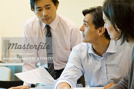 Executives discussing documents