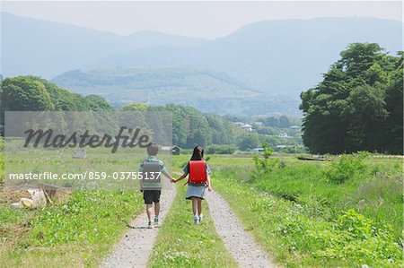 Friends Walking Trough Rural Path