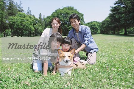 Family Enjoying In a Park With Dog