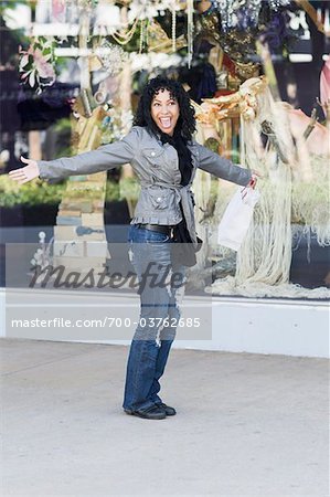 Woman with Open Arms in front of Boutique