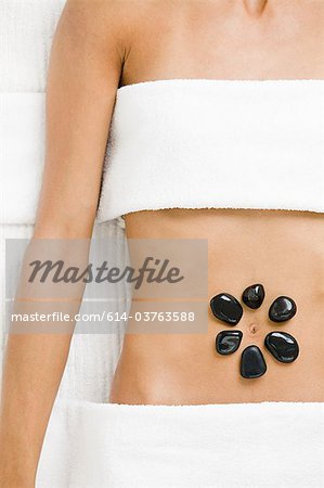Young woman having hot stone therapy