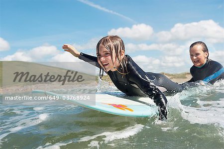 Mother and daughter surfing