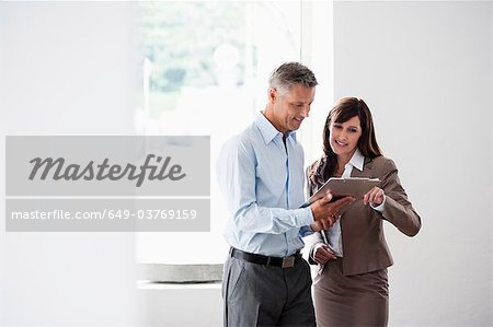 Business couple looking at clipboard