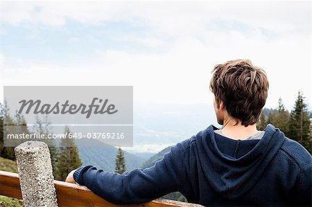 Man sitting on bench watching landscape