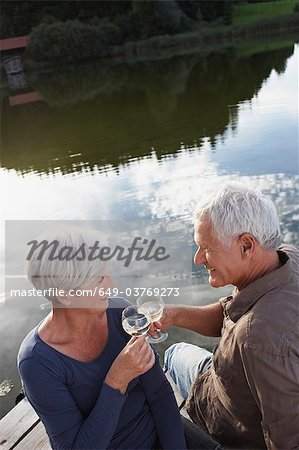 Senior couple clinking glasses of wine