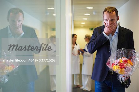 Surprised man with flowers at hospital Surprised man with flowers at hospital