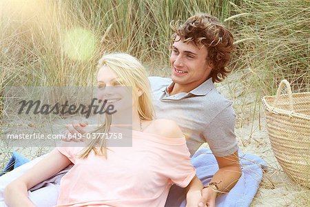 A couple having a romantic beach picnic