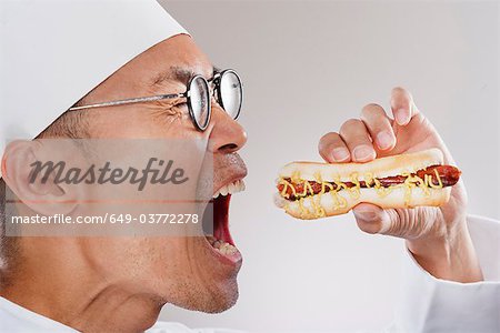 Chef about to eat a hotdog