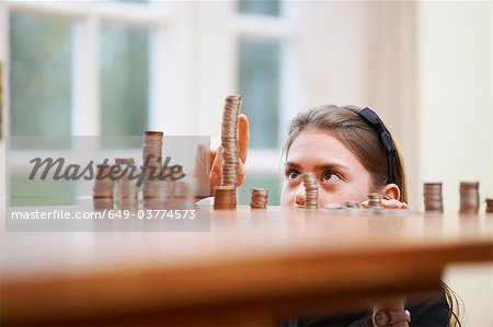 Girl counting piles of money