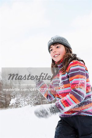 Girl throwing a hand full of snow