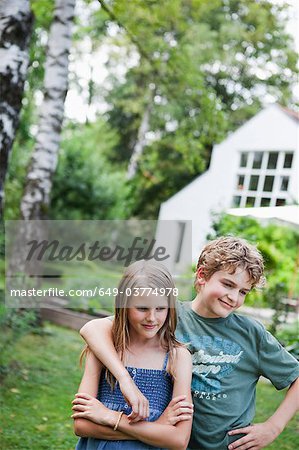 Boy hugging girl in the garden