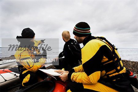 3 men at beach, kayak