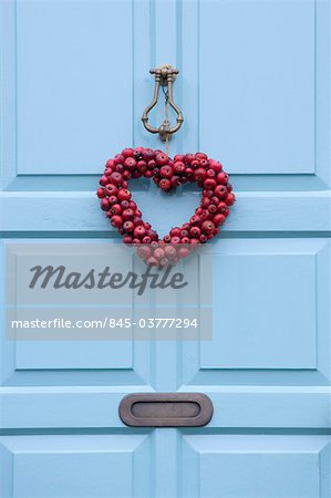 Christmas wreath on a sky blue door, England.