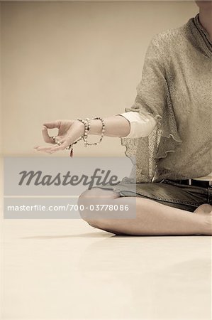 Woman Meditating with Prayer Beads