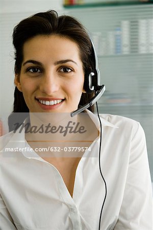 Businesswoman wearing telephone headset, portrait