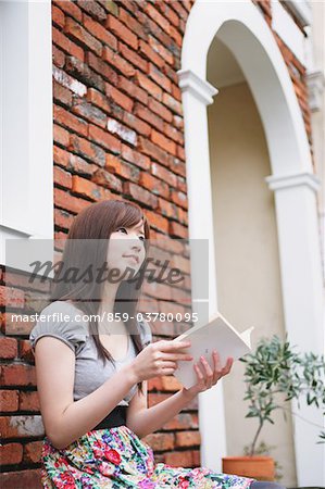 Beautiful Teenage Girl Sitting And Holding Book