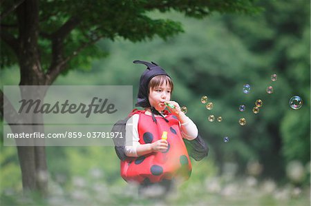 Boy as Ladybird Blowing Bubbles