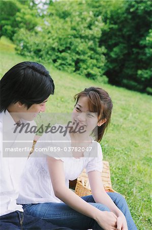 Couple Enjoying Sitting Together in Park