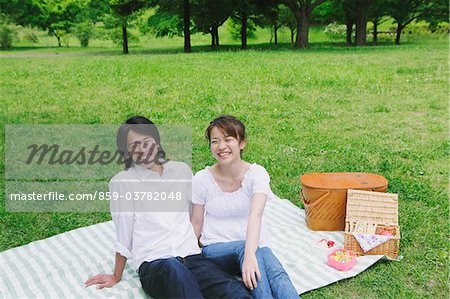Japanese Couple Enjoying Sitting  in Park