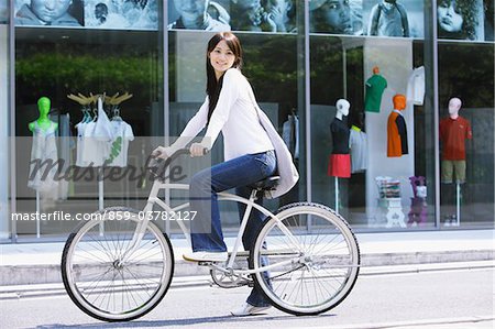 Young Woman  on Cycle outside Shopping Store