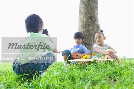 Boy Taking Photographs of his Friends