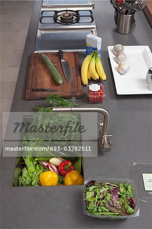 Fresh food preparation on kitchen counter with sink