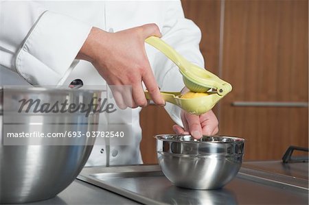 Mid- adult chef squeezing lemon