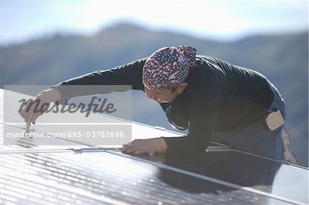 A man working with hills in the background