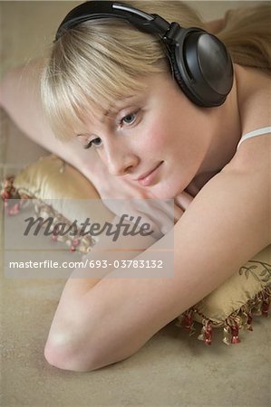 Portrait of a young woman relaxing with headdphones on