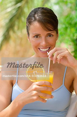 Woman with a glass of fresh orange juice