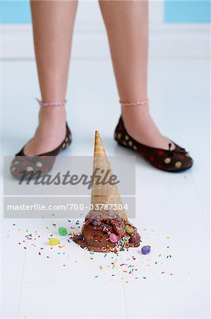 Dropped Chocolate Ice Cream Cone Upside Down on Floor at Girl's Feet Dropped Chocolate Ice Cream Cone Upside Down on Floor at Girl's Feet