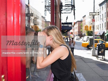 Woman looking through a shop window