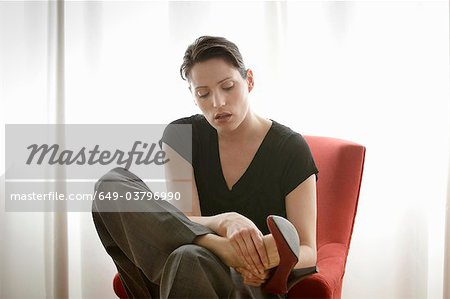 woman rubbing her feet