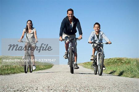Family cycling down country road