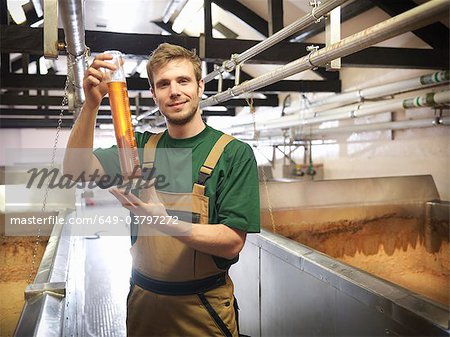 Worker with sample in fermentation room