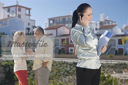 Realestate agent talking on mobile phone