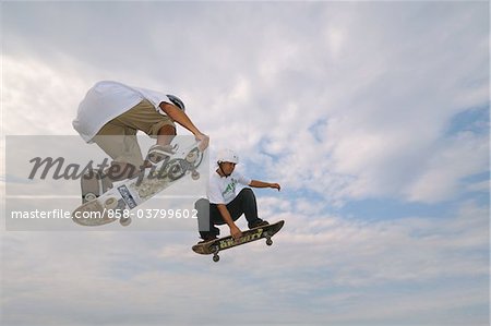 Skateboarders in mid-air