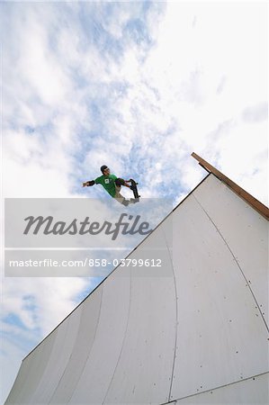 Asian skateboarder in mid-air