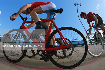 Cyclists racing on velodrome