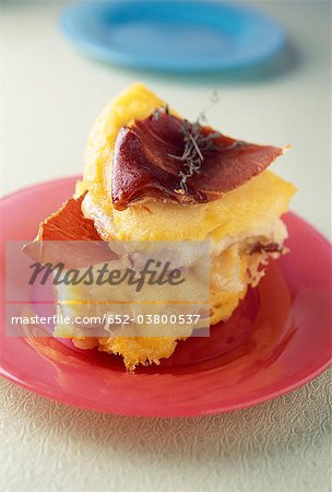 Polenta savoury cake with two cheeses and oven-baked raw ham