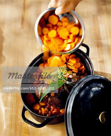 Adding the carrots to the beef stew