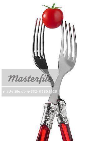 Two forks with cherry tomato