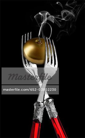 Two forks with golden candle ;candle light diner