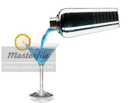 Pouring a Blue lagoon cocktail