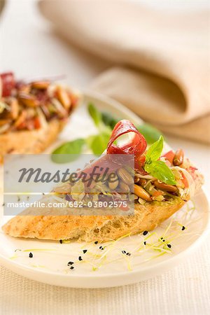 Duck and vegetables on a bite-size slice of bread