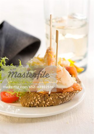 Smoked salmon,egg and shrimp on a bite-size slice of bread Smoked salmon,egg and shrimp on a bite-size slice of bread