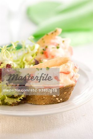 King crab,mayonnaise and white asparagus on a bite-size slice of bread