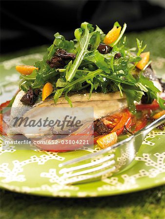 Baked sea bream with tomato and rocket salad