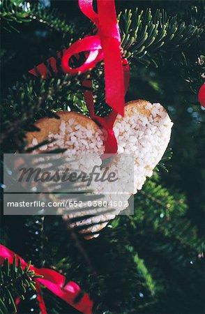 Heart-shaped shortbread cookie hanging on the Christmas tree