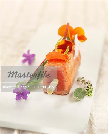 Teriyaki salmon brochette with edible flowers